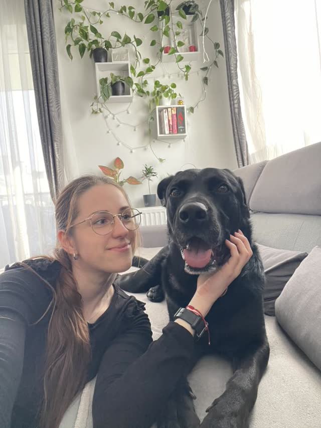 Petsitterka Petsy przytula psa na kanapie podczas opieki